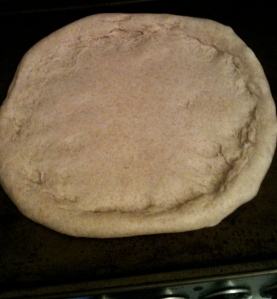 Pizza dough rolled out and rising.